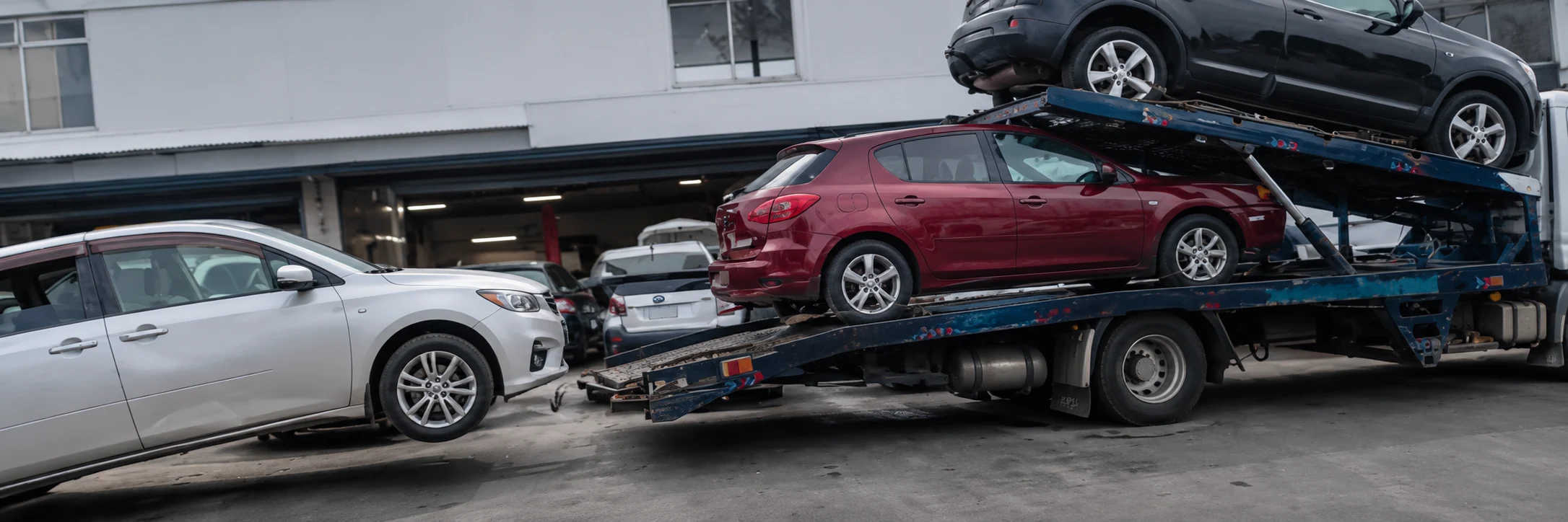 Vehicles on a car transporter outside an Auckland garage